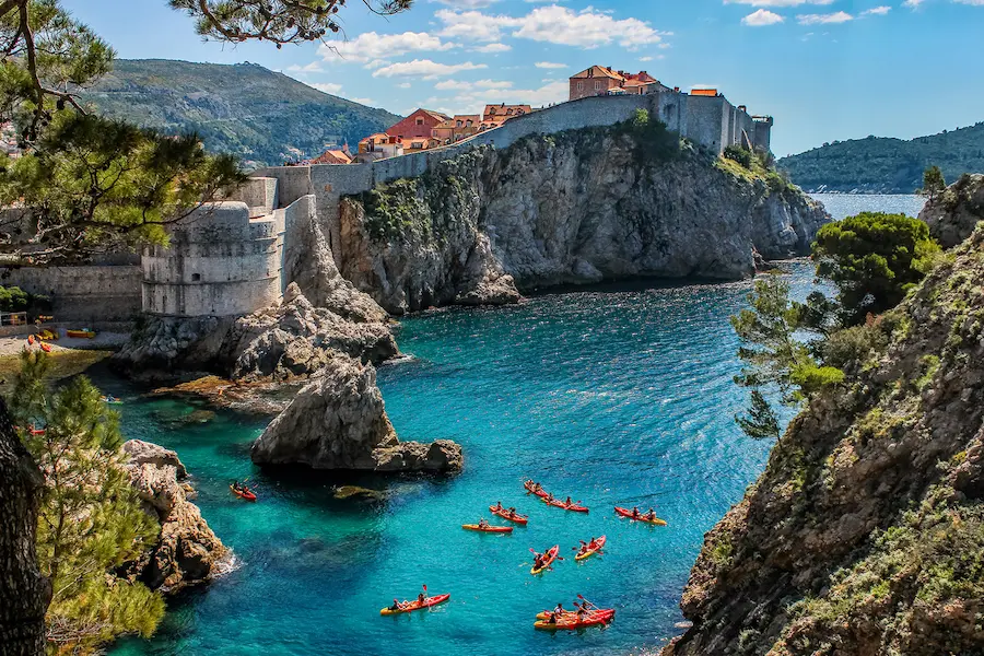 Sea kayaking adventure tour Dubrovnik Croatia - kayaks with city walls in background