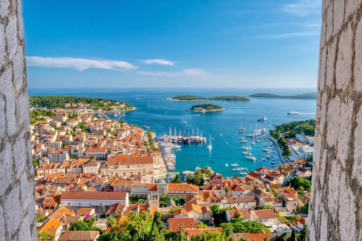 Hvar town harbor Croatia - lavender island with luxury yachts and medieval fortress, Dalmatia Blues tour destination