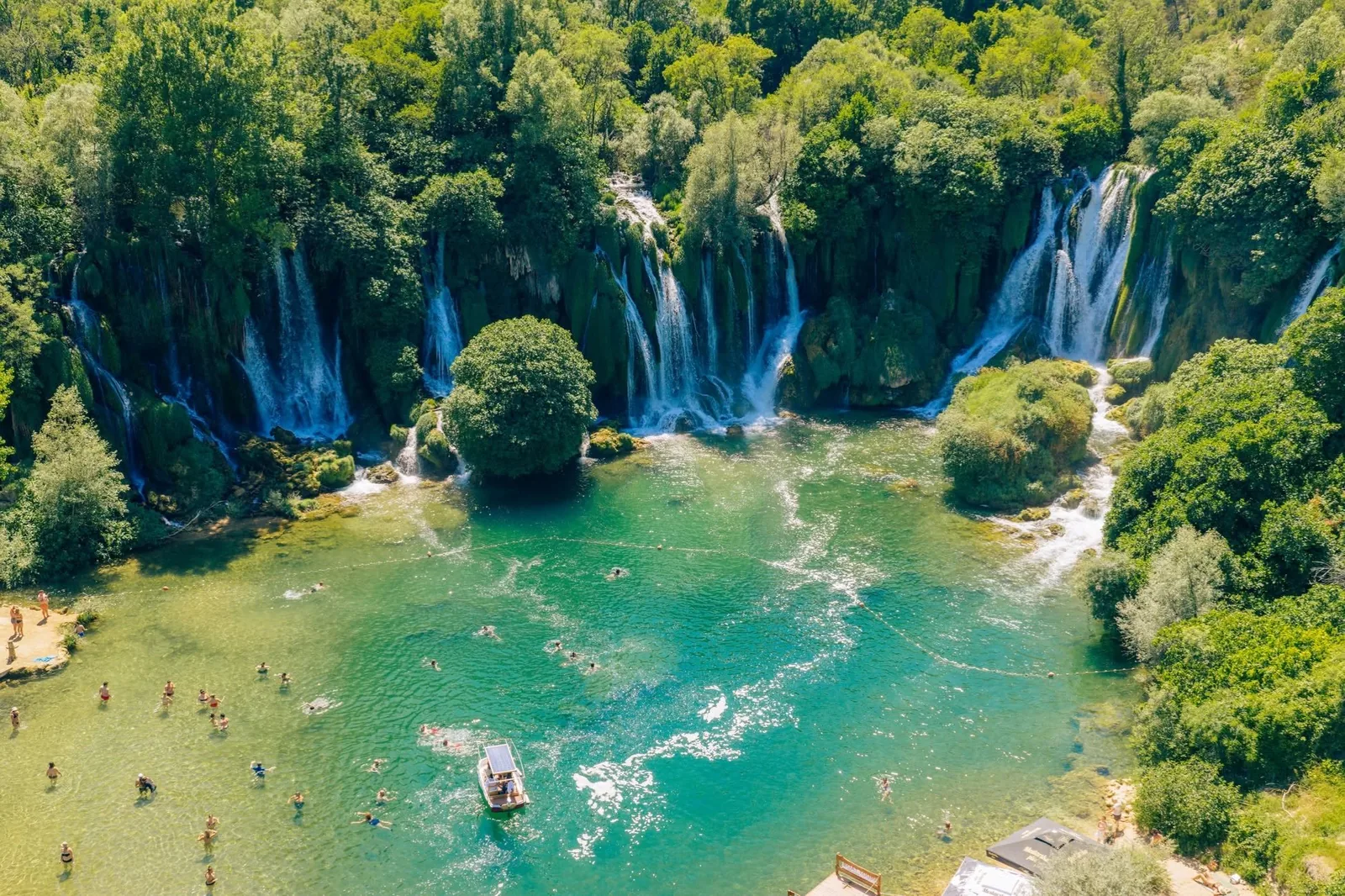 Kravice Waterfalls surrounded by green woodland