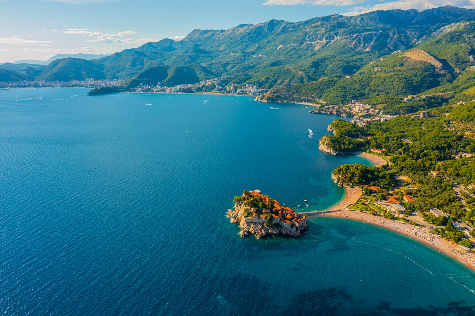 Aerial panorama of Sveti Stefan, the Adriatic coastline and Montenegro’s mountains