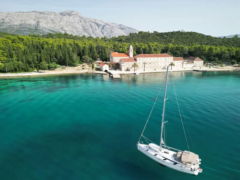 Traditional sailboat cruising Croatian Adriatic coast - authentic sailing adventure with expert skipper and island hopping