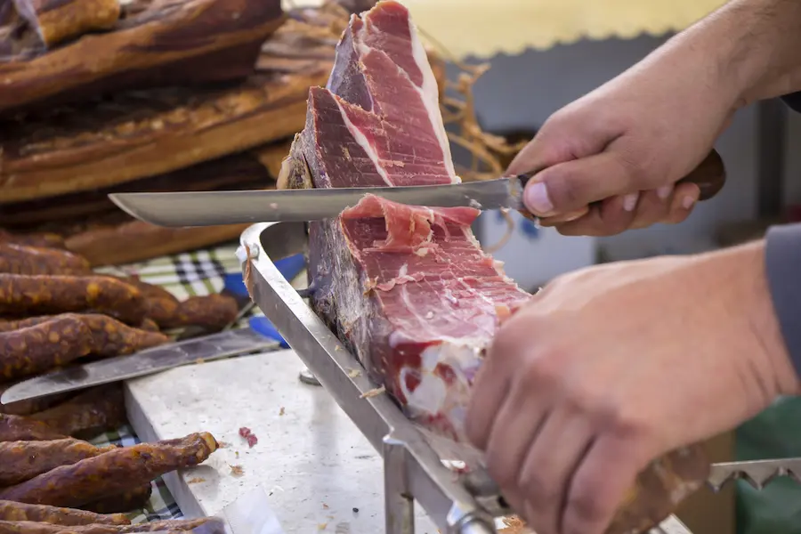 Traditional Dalmatian prosciutto (pršut) being hand-sliced in Croatia - authentic culinary food tour experience