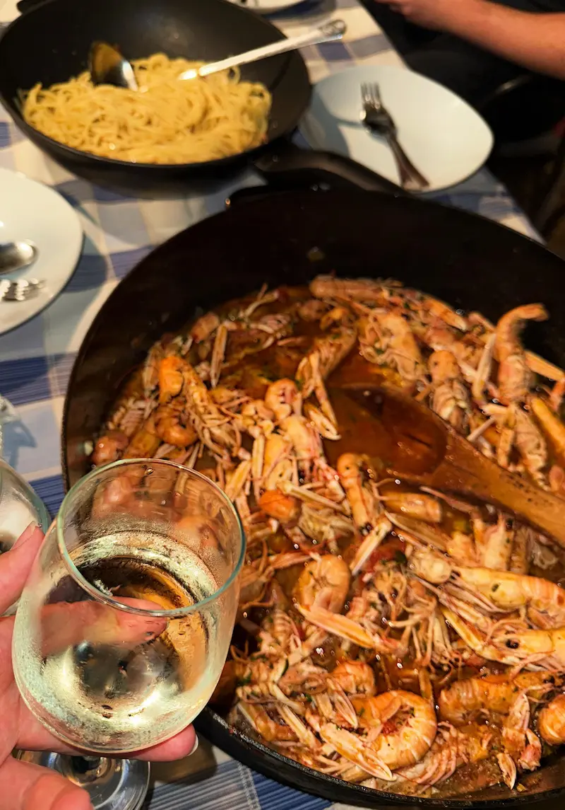 Traditional Croatian shrimp buzara dish being prepared - private cooking class with local family, authentic culinary experience