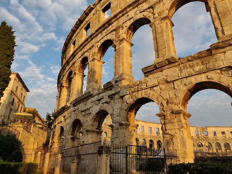 Pula Croatia Roman amphitheater cultural heritage tour - ancient arena at sunset