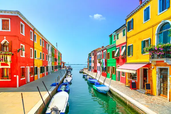 Colorful houses along canal in Burano island Venice Italy